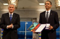 Thorbjorn Jagland presents President Barack Obama with the Nobel Prize medal and diploma during the Nobel Peace Prize ceremony