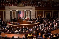 Obama giving a speech to an audience. In the background, the US flag.