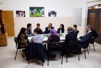 Barack Obama listening to young people talking during a roundtable.