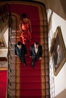 Barack Obama and Hu Jintao, wearing black tuxedo, going down the stairs, followed by Michelle Obama wearing a red dress.