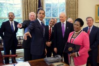 Barack Obama pointing at something, surrounded from left by Eric Holder, Patrick Leahy, Bobby Scott, Richard Durbin, Jeff Sessions, Orrin Hatch, Sheila Jackson-Lee, and Lindsey Graham.